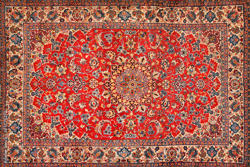 A red and yellow carpet with intricate details